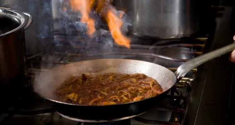 Flambé dish cooking in pan